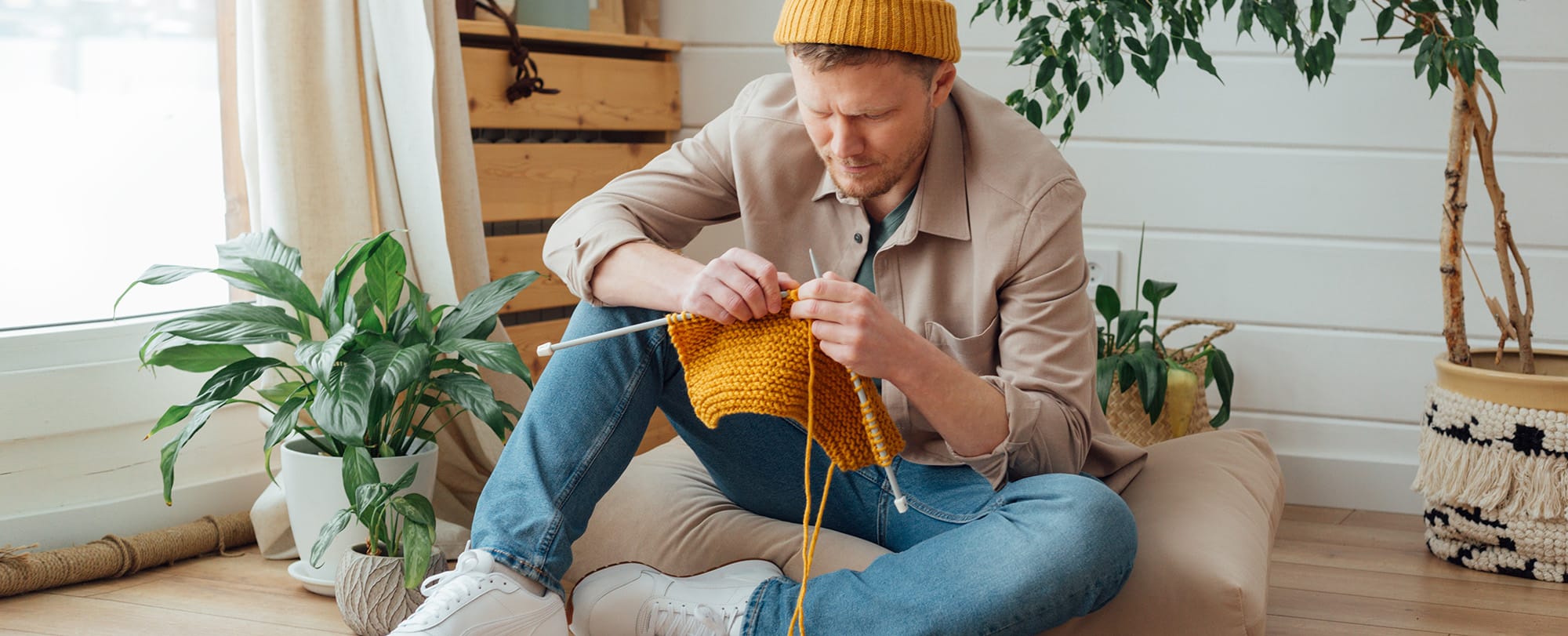 Digital Detox - man sitting on the floor knitting